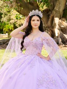 Look radiant in this beaded floral applique long sleeveless cape sleeve dress with an A-line skirt by LizLuo Fiesta 56516. This stunning Quinceañera ball gown is perfect for those who want to feel like a princess. The bodice is made of sheer fabric and decorated with beaded floral lace appliqués, while the skirt is adorned with floral lace appliqués to add the finishing touches. The detachable sleeve cape adds a touch of magic to the dress. House of Wu LizLuo Fiesta Collection Fall 2024 Style Nu Embellished Dresses For Quinceanera, Dama Dresses Quinceanera, Wedding Red Carpet, 1500 Dresses, Cape Sleeve Dress, Ivory Bridesmaid Dresses, Dama Dresses, Debutante Ball, Military Ball Dresses