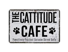 a sign that says the cattide cafe with paw prints on it's side