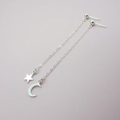 SOLID STERLING SILVER EARRINGSThese celestial earrings make a wonderful gift. The real sterling ear studs are adorned with a tiny moon and a tiny star that dangle elegantly on sterling silver chain. Comes in a gift box, perfect for gift giving. Total earring length is approximately 2 3/4 inches long.ALSO AVAILABLE IN AN ALL MOON DESIGN OR ALL STAR DESIGN Celestial Silver Earrings With Star Charm, Dainty Sterling Silver Earrings With Star Charm, Sterling Silver Celestial Earrings For Gift, Sterling Silver Earrings With Star Charm, Dainty Sterling Silver Star Earrings, Moon Charm Star-shaped Earrings For Gifts, Moon Charm Star Earrings As Gift, Star-shaped Moon Charm Earrings For Gift, Moon Charm Star Earrings For Gift