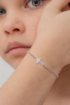 Cross  Name Bracelet   𝐻𝑜𝓌 𝒯𝑜 𝒪𝓇𝒹𝑒𝓇 ✨ Select Finish and the Bracelet length from the menu. ✨ Write your Name and the font type for the Name in the Personalization Box. 𝐼𝓉𝑒𝓂 𝒟𝑒𝓈𝒸𝓇𝒾𝓅𝓉𝒾𝑜𝓃 This gorgeous christening and baptism bracelet will look spectacularly pretty on her tiny wrist. Her name engraved on the cross in specially chosen fonts will add to the beauty of the bracelet. A timeless treasure of enduring beauty and exceptional quality for this momentous occasion is delivered ready to give in our specially designed gift box. With this dazzling design guarantee the joy of your  princesses.  PRODUCT DETAILS: ★Cross height - 20mm ★Cross width - 7.20mm ♥All bracelets come with 1 inch chain extender.             𝒟𝑒𝓁𝒾𝓋𝑒𝓇𝓎 𝒯𝒾𝓂𝑒 ♥ Crafted meticulously with Hi Silver Cross Jewelry For Friendship, Baptism Bracelet, Engraved Cross, Bracelet Initial, Bracelet Dainty, Chain Extenders, Pretty Bracelets, Cross Bracelet, Font Types