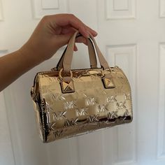 Brand New Gold Metallic Cute Duffle! Super Stylish! Very In With The Small Bag Trend And Metallic Bags! Patent Leather 7.25"W X 5.25"H X 3.75"D Handle Drop: 3" Adjustable Strap: 20.25-22.75" Interior Details: Back Zip Pocket, Front Slip Pocket Lining: 100% Polyester Style # 32h3sgyc1o Gold Crossbody Satchel With Dust Bag, Luxury Gold Satchel For On-the-go, Gold Shoulder Bag With Dust Bag For On-the-go, Gold Shoulder Bag With Dust Bag For Traveling, Metallic Bags, Closet Needs, Future Wardrobe, Metallic Bag, Cute Purses