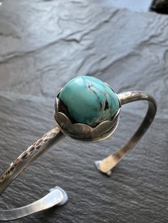 Turquoise and sterling cuff bangle bracelet, bezel set charm silver stacking bracelet, gift for her Featuring a bezel set vintage Tyrone turquoise charm set in sterling silver. The stone sits atop a sterling silver bangle which has been hammered, oxidised and polished. The bracelet is a small 6 - 6.5" wrist.  **Please note this type of bangle fits sideways on to the wrist** You can gently widen the cuff if need be. Wear alone or stacked with other jewellery. **Please note this type of bangle fit Turquoise Stackable Bangle Jewelry, Stackable Turquoise Bangle Jewelry, Turquoise Spiritual Stackable Jewelry, Spiritual Stackable Turquoise Jewelry, Vintage Adjustable Stackable Cuff Bracelet, Turquoise Jewelry With Oyster Bracelet As A Gift, Adjustable Turquoise Stackable Jewelry, Unique Turquoise Bracelet Jewelry, Artisan Round Turquoise Cuff Bracelet