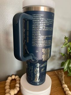 a blue coffee cup sitting on top of a wooden table