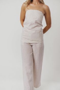 Elevate your outfit instantly with the Myrna Linen Top! This beauty is perfect for dressing up and going out, or styling with a cardigan for more casual days. You'll love its linen breathability and luxury feel. Pair with our Ellen Linen Pants in Khaki for the perfect summer set! FIT: Runs true to size. MATERIAL: 100% Linen. GARMENT DETAILS: Linen tube top with center back zipper. Features a longer length drape, with an A-line flare. SIZE GUIDE: XS (0-2) / S (2-4) / M (6-8) / L (10-12) / XL (14-16) MODEL DETAILS: MISSES Mackenzie - Size S Heather - Size S Bust 34" 34" Waist 27.5" 27.5" Hips 40.5" 37.5" Height 5'7" 5'7" Garment Details, Summer Set, Linen Top, Linen Pants, Long Length, Perfect Summer, Tube Top, Size Guide, Going Out