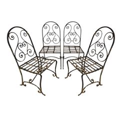 three wrought iron patio furniture set with four chairs and one table, all in the same pattern