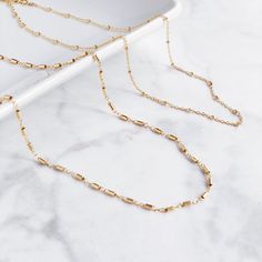 "Handcrafted from the most delicate, hypoallergenic 14k gold filled chain, the Bianca Mini Necklace is made to add a touch of effortless glimmer to your everyday style. You'll love the versatility of its 14\"-16\" adjustable chain, allowing you to wear it solo, or to layer flawlessly with your other Lavender Crush favorites.   ☾ THE DETAILS ☾ * Adjustable from 14\" to 16\", allowing you to choose your perfect length for layering or for different necklines. * Handcrafted with the most delicate, h Minimalist Gold Plated Satellite Chain Necklace, Gold Satellite Chain Necklace Minimalist Style, 14k Gold-filled Delicate Clavicle Chain Necklace, Delicate 14k Gold-filled Clavicle Chain Necklace, Gold Satellite Chain Necklace In Minimalist Style, Minimalist Bar Necklace With Delicate Chain For Layering, Dainty Gold-plated Layered Necklace With Delicate Chain, Minimalist 14k Gold Filled Layered Necklace For Everyday, Gold Dainty Bar Necklace With Adjustable Chain