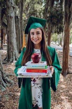 a girl in graduation gown holding books and an apple