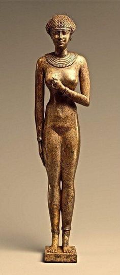 an ancient statue of a woman holding a bird