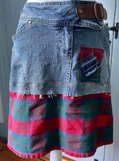 This upcycled super comfy denim skirt has a wide plaid hem, with appliqued adornments to match. It has a decorative snap belt, button, and zipper closing. The waist is about 34" and the length is approximately 18". Denim Patchwork Skirt For Fall, Fall Denim Patchwork Skirt, Casual Plaid Skirt With Patchwork, Cotton Patchwork Skirt For Fall, Casual Denim Skirt Upcycled, Casual Fitted Skirt Reworked, Casual Fitted Upcycled Denim Skirt, Casual Upcycled Denim Skirt, Casual Reworked Medium Wash Denim Skirt