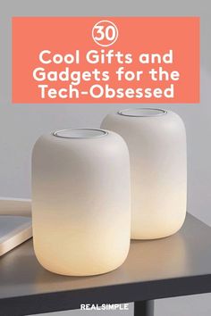 two white vases sitting on top of a table with the words cool gifts and gadgets for the tech - obsesed