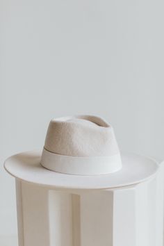 I am THE showstopper. Wear me around town and receive all of the oos and ahs as you perfect your outfit with my white radiance. I am here to impress. Modern White Hat With Curved Brim, Classic White Hat For Fall, Luxury White Hats For Spring, Chic Fitted White Hat, Chic White Fitted Hat, Luxury Fitted White Hat, Chic White Hat For Fall, Chic White Fall Hat, Wool Fedora