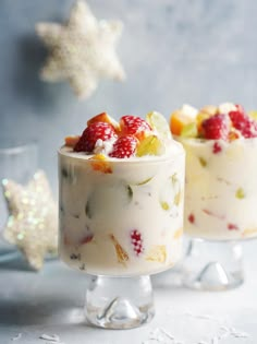 two small desserts with fruit on top are sitting next to each other in glass dishes