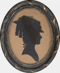 an old photo of a woman's head in a frame