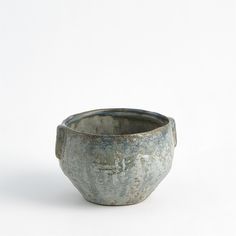 a gray bowl sitting on top of a white table