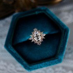 an engagement ring sitting in a velvet box