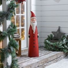 a statue of santa claus on the front porch