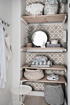 an organized closet with shelves and baskets