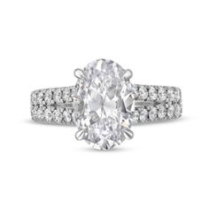 an oval cut diamond ring with pave set shoulders