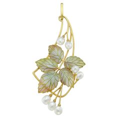 An Art Nouveau enamel and pearl pendant by Falize, the five realistiacly caved gold leaves with green and pink plique-à-jour enamel decorations, embellished with seven natural baroque-shaped pearls, all to yellow gold openwork frame and pendant loop, bearing French gold eagle marks, unsigned, accompanied by original fitted case, circa 1900, measuring approximately 7x3cm, gross weight 6.3grams. This antique pendant is in very good condition, with minor signs of wear on the enamel consistent with Diamond Drop Pendant, Diamond Flower Pendant, Art Nouveau Pendant, Diamond Bows, Gold Eagle, French Jewelry, Antique Pendant, Art Nouveau Jewelry, Heart Brooch