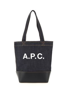 A.P.C. Axel small tote bag crafted in cotton denim featuring contrasting logo print on front and leather base with contrasting stitching. Unlined interior, one inner zipped flat pocket. Jean Touitou, Craft Tote Bag, Denim Tote Bags, Small Tote Bag, Denim Tote, Small Tote, Sneaker Wedge, Dark Navy Blue, Roberto Cavalli