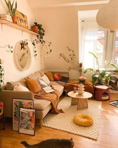 a living room filled with furniture and lots of plants