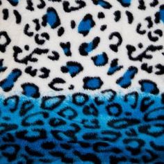 a blue and white animal print blanket with black spots on the top, in front of it