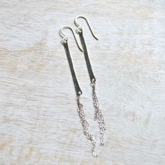 "These alluring vertical bar earrings come in either sterling silver or gold filled. They're made from 14g wire that's been hammered down and has fine cable chains dangling from them. The bars are 1 1/2\" long and longest chain is 1 1/2\". You'll definitely want to get one of each!" Minimalist Hammered Dangle Linear Earrings, Gold Bar Earrings, Glass Drop Earrings, Vertical Bar, Sea Glass Earrings, Bar Earrings, Shell Earrings, Hammered Silver, Glass Earrings