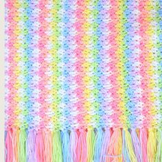 a multicolored crocheted blanket with fringes on it and the words, rainbow