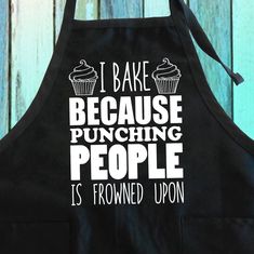 a black apron that says i bake because punching people is ironed upon it