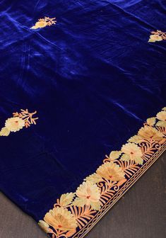 A touch of glamour and the luxury of velvet! This saree comes from the Kashmir Valley! Colorful Florals and Foliage that are reminiscent of the scenery around, grace the borders and pallu of this magnificent saree! The style of embroidery is the aari, and it has been done with a hand machine and takes several days and two people working in unison to create this beauty! Set in plush velvet fabric, this saree is all you need to make a powerful style statement!  This saree is ready to wear with fall and pico done.  An unstitched blouse fabric is included. *Note: There may be minor variations in the shade, the texture of the product. Hues/textures show differently due to variations in screen settings and other factors, *Note: This saree may have slight inconsistencies. These are characteristic Traditional Velvet Wear With Dori Work, Velvet Lehenga With Pallu For Eid, Velvet Saree For Diwali With Traditional Drape, Semi-stitched Velvet Traditional Wear With Dori Work, Velvet Dupatta With Pallu For Eid, Eid Velvet Dupatta With Dori Work, Diwali Velvet Embroidered Fabric With Dupatta, Diwali Velvet Traditional Wear With Resham Embroidery, Velvet Traditional Drape For Diwali