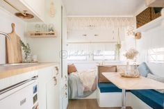 the interior of a tiny home with a kitchen and dining area in front of it