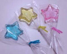 three star shaped lollipops in plastic bags