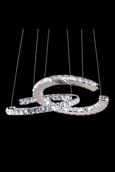 a chandelier hanging from strings in the shape of an o - shaped object