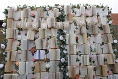 an arrangement of books with flowers on them