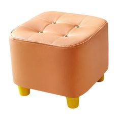 the foot stool is made from leather and has buttons on each side, along with wooden legs