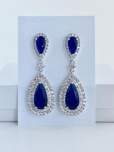 Absolutely stunning!! blue sapphire cubic zirconia large teardrop bridal earrings in rhodium plated brass setting. Earrings feature a large teardrop with pear cut blue sapphire cubic zirconia center surrounded by two rows of clear zirconia crystals. Teardrop dangles from a blue sapphire cubic zirconia teardrop ear stud. Total length of the earrings is 5.5 cms.To browse my collection click :https://www.etsy.com/your/shops/fantasycrystals Blue Pear-shaped Crystal Jewelry, Blue Elegant Teardrop Pendant Earrings, Blue Elegant Teardrop Earrings, Elegant Blue Teardrop Earrings, Blue Pear-shaped Teardrop Earrings, Blue Cubic Zirconia Chandelier Earrings For Party, Elegant Blue Teardrop Pendant Earrings, Elegant Blue Crystal Teardrop Earrings, Blue Pear-shaped Teardrop Earrings For Formal Occasions