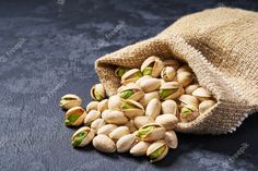 pistachio nuts in a burlock bag on a dark background with copy space