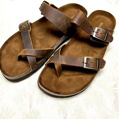 These Mountain Sole Slip-On Sandals Feature A Crisscross All Leather Strap That Fits Around The Toe And A Molded, Faux Suede Lined, Cork-Wrapped Footbed For Comfort And Support. Leather Has Natural Imperfections On The Surface. Color: Brown 1" Heel Height Contoured Footbed With Heel Cup Leather Upper/Remainder Man Made Two Adjustable Buckles Easy Slip-On Eva Outsole New Without Tags Casual Footbed Sandals With Buckle And Cross Strap, Casual Footbed Sandals With Buckle Closure, Casual Leather Toe Loop Footbed Sandals, Casual Footbed Sandals With Leather And Cross Strap, Casual Brown Sandals With Cross Strap, Casual Brown Cross-strap Sandals, Casual Brown Cross Strap Sandals, Casual Sandals With Cross Strap And Heel Loop, Casual Sandals With Heel Loop And Cross Strap