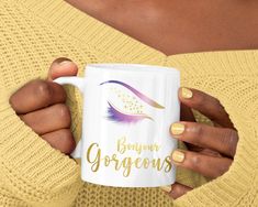 a woman is holding a coffee mug with the words burner gorgeous on it