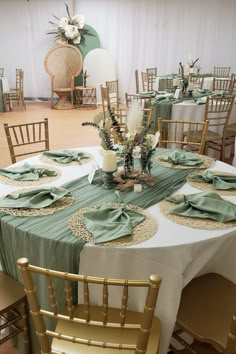 Embrace rustic charm at your event tables. White tablecloths and sage green table runners create a serene base with gold woven placemats and stylishly folded sage green napkins on top. The center hosts candles in themed holders, surrounded by rustic flower arrangements. A Chiara stand backdrop, draped in white and sage green spandex, showcases a boho-themed flower arrangement, completing the rustic allure for an enchanting celebration. 🌿✨ #RusticStyle #EventDecor Rustic Event Decor, Sage Green Napkins, Green Table Runners, Sage Green Table, Rustic Flower Arrangements, Event Tables, Flowers Candles, Green Napkins, Event Decor