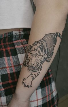 a person with a tiger tattoo on their arm