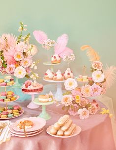 a table topped with lots of cakes and desserts