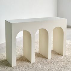 a white bench sitting on top of a carpet covered floor