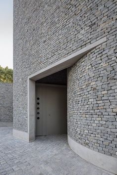 an entrance to a building made out of bricks