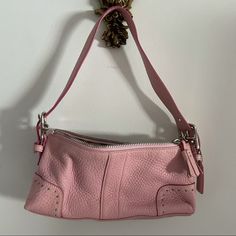 Authentic Coach Shoulder Bag With Soft Pebbled Leather. Zips Closed And Has An Interior Zippered Pocket. Comes With The Leather Hang Tag And Dust Bag. In Excellent New Condition. Approximate Measurements: Length 10, Height 4.5”, Width 2.25”, Drop 9” Strap Is Adjustable With Silver Buckles. Coach Shoulder Bag, Pretty Bags, Coach Leather, Hang Tags, Pebbled Leather, Coach Bags, Leather Shoulder Bag, Pink Color, Dust Bag