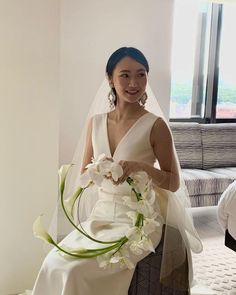 a woman in a wedding dress holding a bouquet