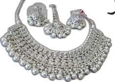 Traditional White Bridal Sets For Wedding, Silver Bridal Necklace For Wedding And Eid, Silver Jhumkas With Stone Work For Reception, Festive White Bridal Sets For Weddings, Bollywood Style White Bridal Sets For Wedding, White Jhumkas For Wedding And Eid, White Bridal Sets For Eid Festive Occasion, White Bridal Sets For Eid Festivities, Silver Bollywood Bridal Necklace For Marriage