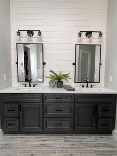 a bathroom with double sinks and two mirrors on the wall next to eachother