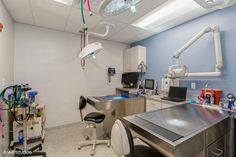 an operating room with medical equipment on the counter and ceiling lights hanging from the ceiling