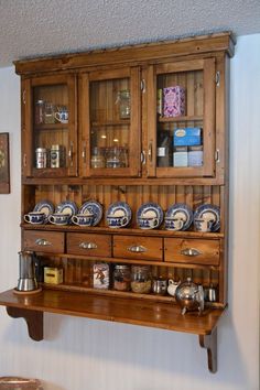 an old wooden cabinet with many plates on it